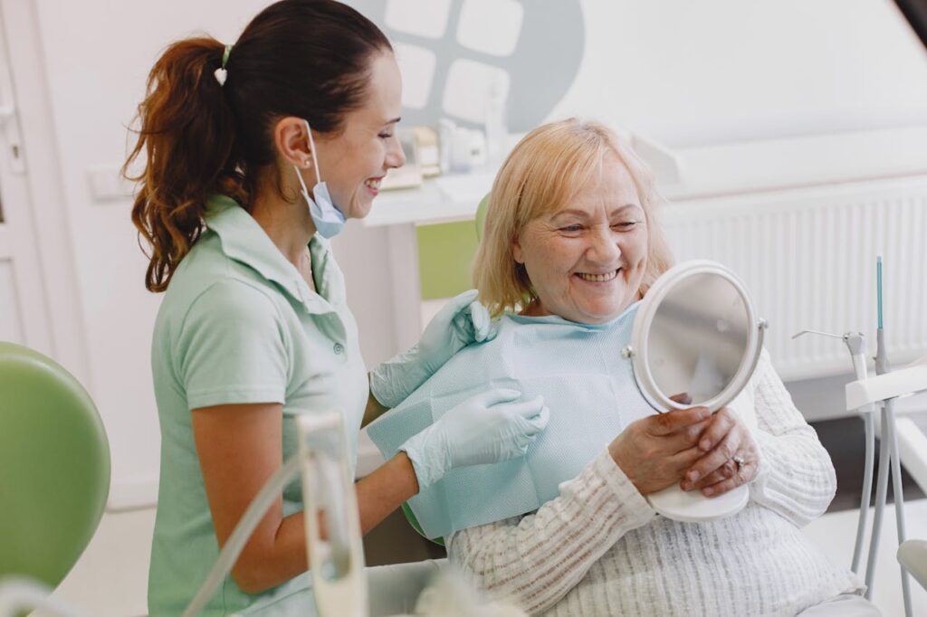 Dental anxiety Shenfield Essex. Photo of a smiling patient in a dentist's chair with a member of staff.